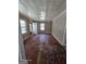 View of the interior of a home with peeling wood floors, white trim, and beige colored walls at 1243 Hill Nw St, Conyers, GA 30012