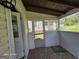 View of the enclosed porch with doorway and screen door at 1243 Hill Nw St, Conyers, GA 30012