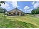 Large yard with grass, mature trees, stone patio, shed, and fenced perimeter at 1815 Sharon Rd, Cumming, GA 30041