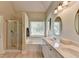 Bathroom with tiled floors, glass shower, soaking tub under window, and double vanity with granite countertop at 1815 Sharon Rd, Cumming, GA 30041