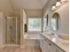 Bathroom featuring a shower, soaking tub, and double vanity at 1815 Sharon Rd, Cumming, GA 30041