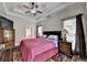 Cozy bedroom featuring a ceiling fan and ensuite bathroom at 1815 Sharon Rd, Cumming, GA 30041