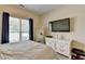 Bright bedroom with white dresser, mirror, and a large window at 1815 Sharon Rd, Cumming, GA 30041