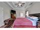 Cozy bedroom featuring a ceiling fan, ensuite bathroom, and tv at 1815 Sharon Rd, Cumming, GA 30041