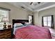 Comfortable bedroom with large windows and a ceiling fan at 1815 Sharon Rd, Cumming, GA 30041