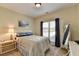 Well-lit bedroom with neutral tones and a large window at 1815 Sharon Rd, Cumming, GA 30041