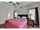 Cozy bedroom featuring a ceiling fan, neutral walls, and an ensuite bathroom at 1815 Sharon Rd, Cumming, GA 30041