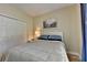 Neutral bedroom with a queen bed, closet, and a large window at 1815 Sharon Rd, Cumming, GA 30041