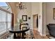 Bright foyer featuring a round table, large arched window, hardwood floors, and an elegant chandelier at 1815 Sharon Rd, Cumming, GA 30041