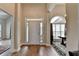 Elegant foyer with wood flooring, a high ceiling, and a view of a sunlit room with large windows at 1815 Sharon Rd, Cumming, GA 30041
