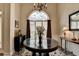 Foyer featuring a round table, arched window, hardwood floors, and neutral wall colors at 1815 Sharon Rd, Cumming, GA 30041