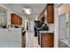 View of the kitchen featuring wooden cabinetry, black appliances and granite countertops at 1815 Sharon Rd, Cumming, GA 30041