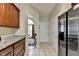 View of the kitchen with wooden cabinets, granite countertops and stainless steel refrigerator at 1815 Sharon Rd, Cumming, GA 30041