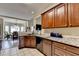 Kitchen displays wooden cabinets, granite countertops and seamless flow to the dining area at 1815 Sharon Rd, Cumming, GA 30041