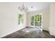 Bright dining area with a window and glass doors leading to an outdoor deck at 3684 Regent Nw Dr, Kennesaw, GA 30144