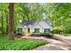 Charming single Gathering home with a lush, wooded front yard and driveway at 3684 Regent Nw Dr, Kennesaw, GA 30144