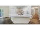 Kitchen with a large island, white cabinets, and modern appliances at 3684 Regent Nw Dr, Kennesaw, GA 30144