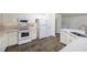 Modern kitchen featuring white cabinets, updated appliances, and granite countertops at 3684 Regent Nw Dr, Kennesaw, GA 30144