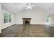 Bright, open living room with a stone fireplace and large windows, offering plenty of natural light at 3684 Regent Nw Dr, Kennesaw, GA 30144