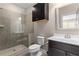 Tiled bathroom featuring a glass shower, toilet, vanity and modern finishes at 6763 Encore Blvd, Atlanta, GA 30328