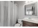 Bright bathroom with white shower curtain, vanity, and decorative mirror at 6763 Encore Blvd, Atlanta, GA 30328