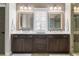Bathroom featuring a double vanity with a framed mirror above each sink and a shower at 6763 Encore Blvd, Atlanta, GA 30328