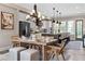 Dining area boasts stylish chandelier and seamlessly connects to the kitchen with a large island and stainless appliances at 6763 Encore Blvd, Atlanta, GA 30328