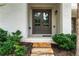 Inviting entrance with stone steps and front door, framed by lush landscaping and painted brick at 6763 Encore Blvd, Atlanta, GA 30328