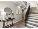 Elegant entryway features a staircase, stylish decor, wood floors, and great lighting to welcome you home at 6763 Encore Blvd, Atlanta, GA 30328