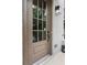 Stylish front door with sidelights and a contemporary light fixture accents the painted brick facade at 6763 Encore Blvd, Atlanta, GA 30328