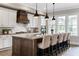 Gourmet kitchen features a large island with seating, modern appliances, and stylish pendant lighting at 6763 Encore Blvd, Atlanta, GA 30328