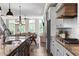 Open concept eat in kitchen with white cabinets flowing into dining and living areas at 6763 Encore Blvd, Atlanta, GA 30328