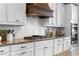 Bright kitchen features white cabinets, granite countertops, and a stylish range hood at 6763 Encore Blvd, Atlanta, GA 30328