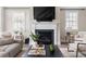 Bright living room is designed with a fireplace, large windows, and comfortable seating at 6763 Encore Blvd, Atlanta, GA 30328