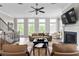 Bright living room with large windows, fireplace, and stylish furniture provides a comfortable gathering space at 6763 Encore Blvd, Atlanta, GA 30328