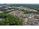 Aerial shot of a neighborhood community with mature trees, and a mix of homes and commercial buildings at 6763 Encore Blvd, Atlanta, GA 30328