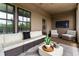 Comfortable covered patio with stylish wicker seating, large windows, and a mounted television for outdoor enjoyment at 6763 Encore Blvd, Atlanta, GA 30328