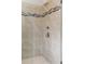 Modern tiled shower featuring bronze fixtures and stylish decorative band at 6763 Encore Blvd, Atlanta, GA 30328