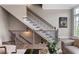 A staircase with dark metal balusters and wood handrails lead upstairs at 6763 Encore Blvd, Atlanta, GA 30328