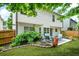 Charming backyard featuring a patio with comfortable seating, lush greenery, and a well-maintained lawn at 1326 Castleberry Dr, Buford, GA 30518