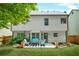 Spacious backyard featuring a patio with furniture, lush greenery, and well-maintained lawn; ideal for outdoor living at 1326 Castleberry Dr, Buford, GA 30518