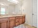 Bathroom featuring a double sink vanity with rich wood cabinets, neutral countertops, and a large mirror at 1326 Castleberry Dr, Buford, GA 30518