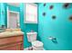 Compact bathroom with a toilet, vanity, and stylish wall decorations at 1326 Castleberry Dr, Buford, GA 30518
