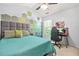 Bedroom with unique hexagon wall design, gaming setup, and bright window at 1326 Castleberry Dr, Buford, GA 30518