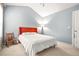 Cozy bedroom with white bedding, rocking chair, and a soft blue wall color that enhances the relaxing atmosphere at 1326 Castleberry Dr, Buford, GA 30518