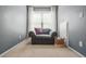 Cozy room with gray walls, comfortable chair, and soft carpet perfect for reading or relaxation at 1326 Castleberry Dr, Buford, GA 30518