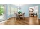 Sunny dining area with wood floors, access to the backyard, and seating for four near the dining room at 1326 Castleberry Dr, Buford, GA 30518