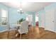 Dining room with wood floors, chandelier, and seating for four near a window at 1326 Castleberry Dr, Buford, GA 30518