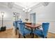 Charming dining area with stylish blue chairs, wood accents, and elegant lighting fixtures at 1326 Castleberry Dr, Buford, GA 30518