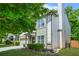Charming home exterior with a stone and siding facade, well-manicured lawn, and lush green landscaping at 1326 Castleberry Dr, Buford, GA 30518